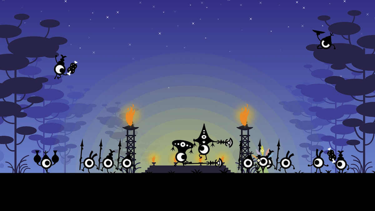 A bunch of patapon characters, all of which are small and circular with one eye, gathered around a camp at night with a few torches providing light